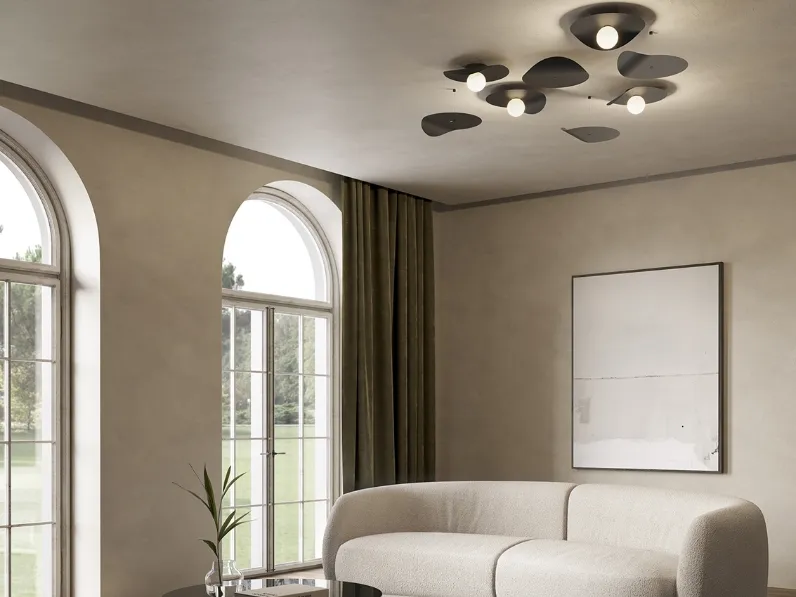 Lampada da parete con disco metallico che ricorda le foglie di un albero portate dal vento Flow Ceiling di Kundalini